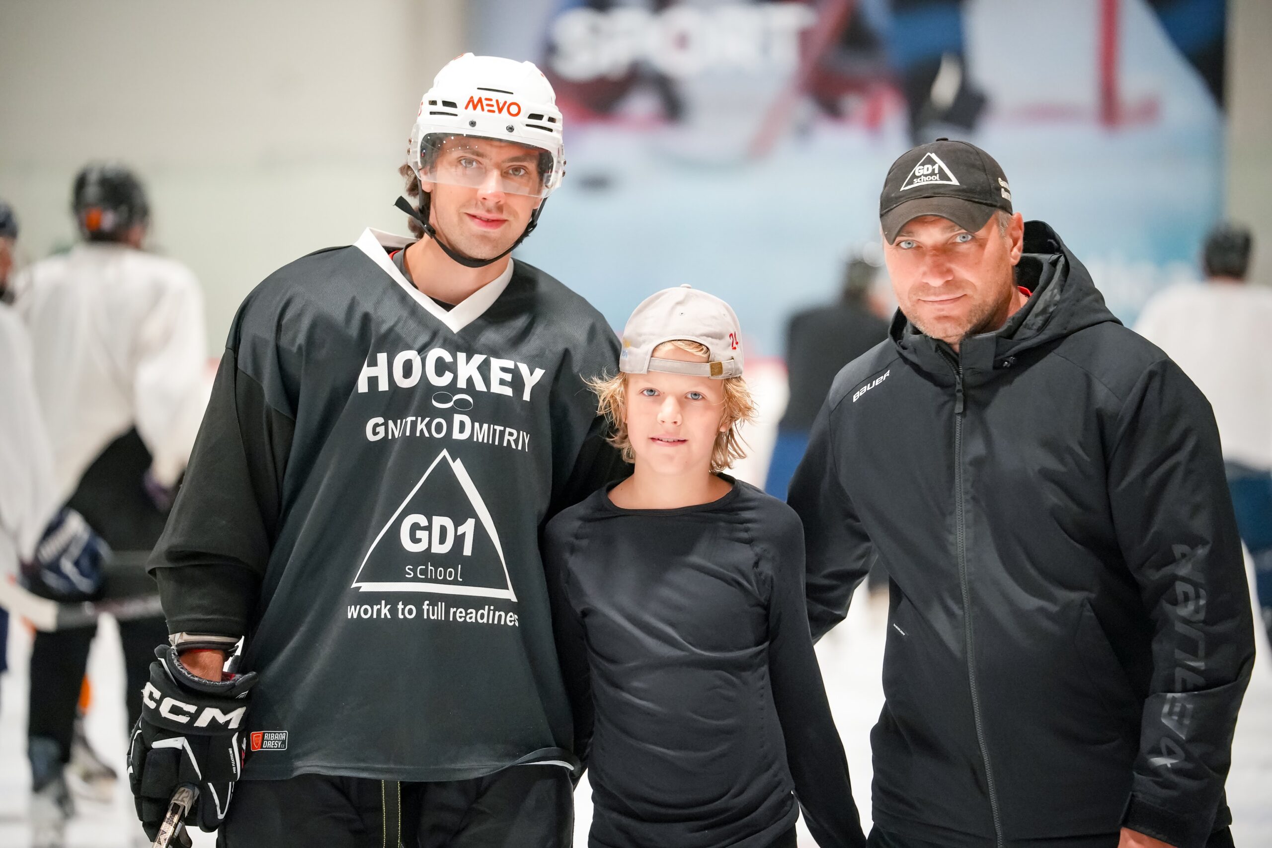 A GD1 coach with two players at the rink