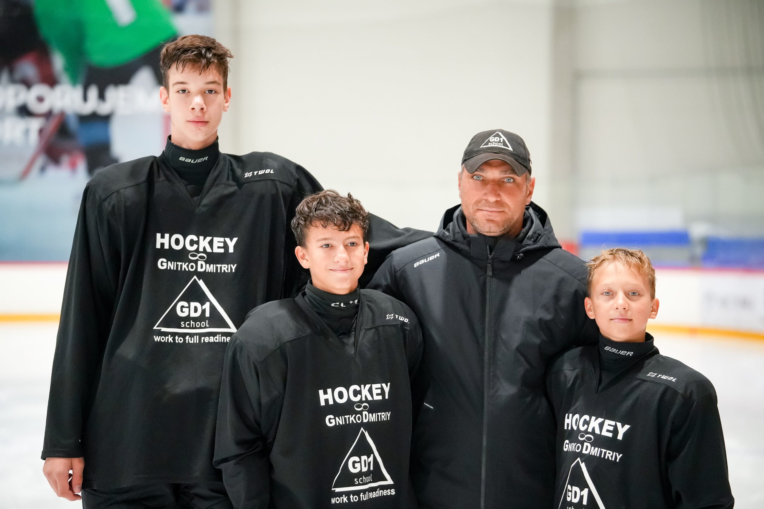 Coach Dmitriy Gnitko with three young players