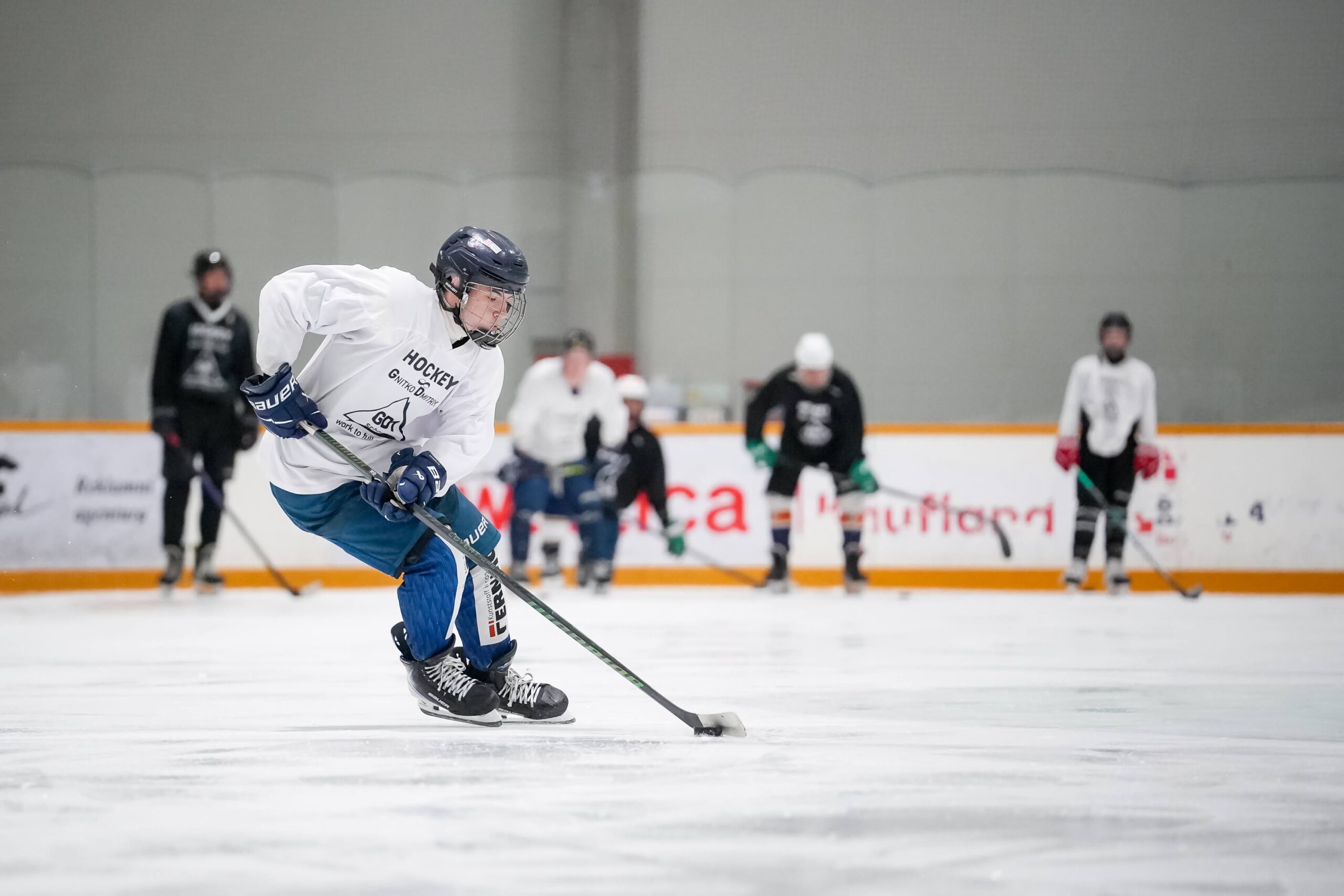 A player practicing puck control on the ice