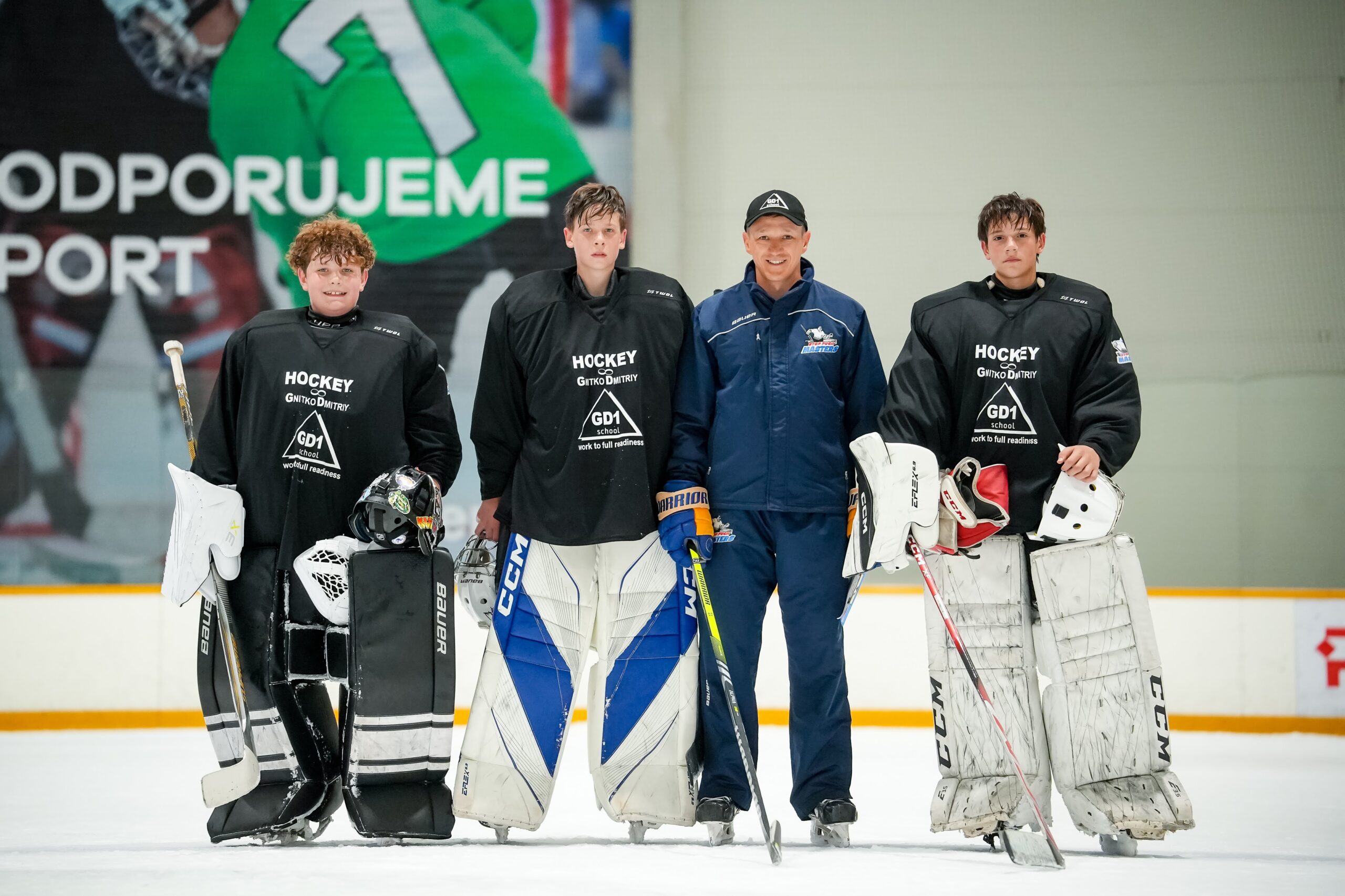 Coach with three goalkeepers after practice