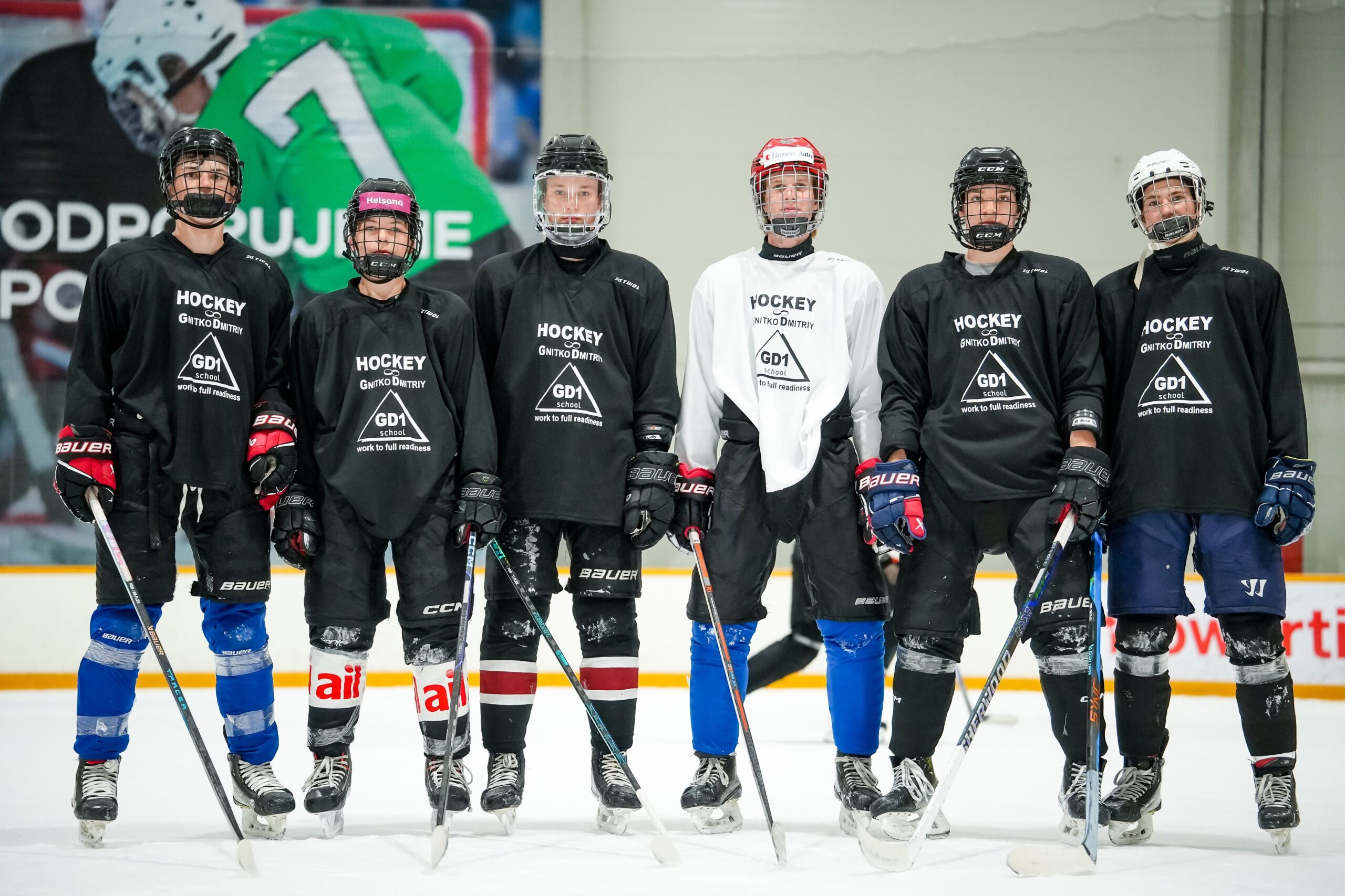 Hockey players lined up on the ice after training