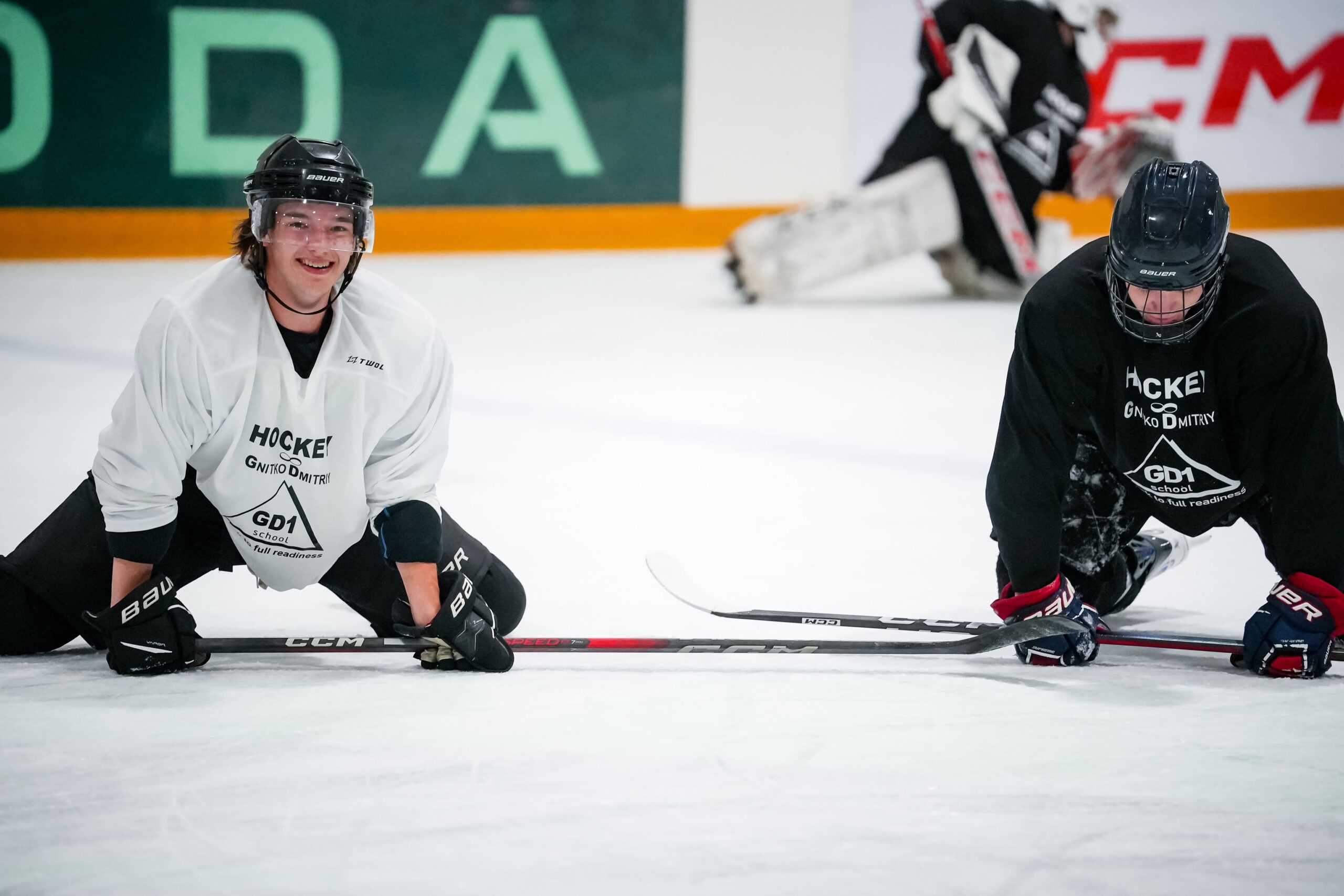 Two players stretching on the ice