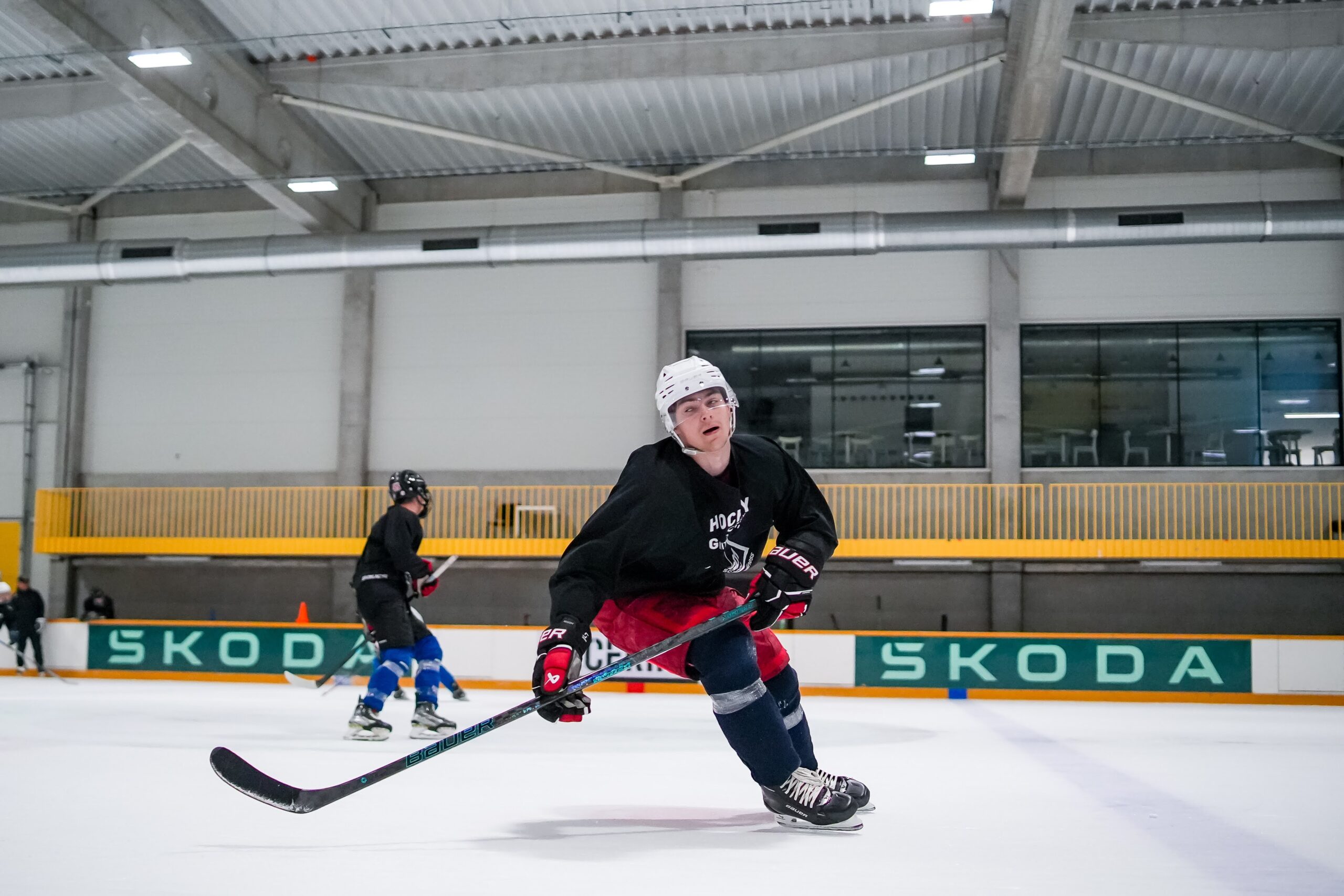 A player skating with a puck during practice