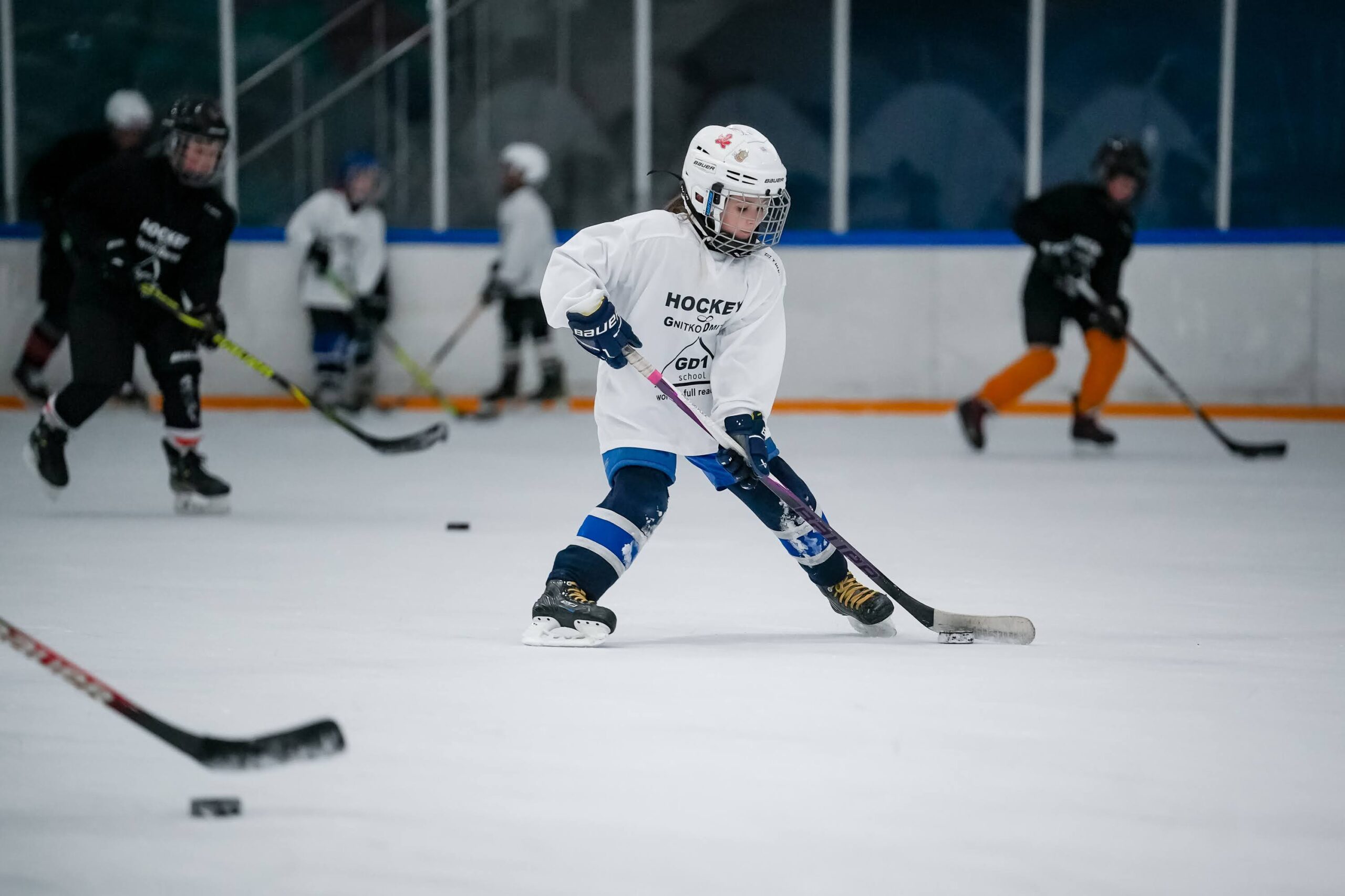A player controlling the puck during a skating drill
