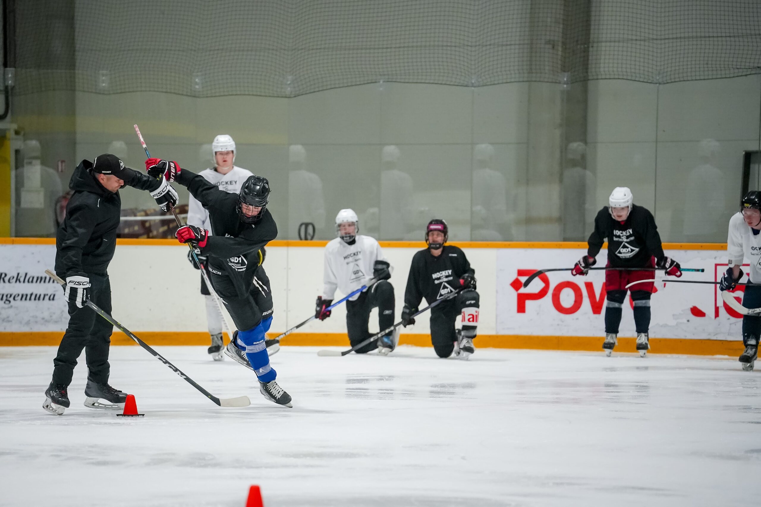 Coach demonstrating a skating drill during practice